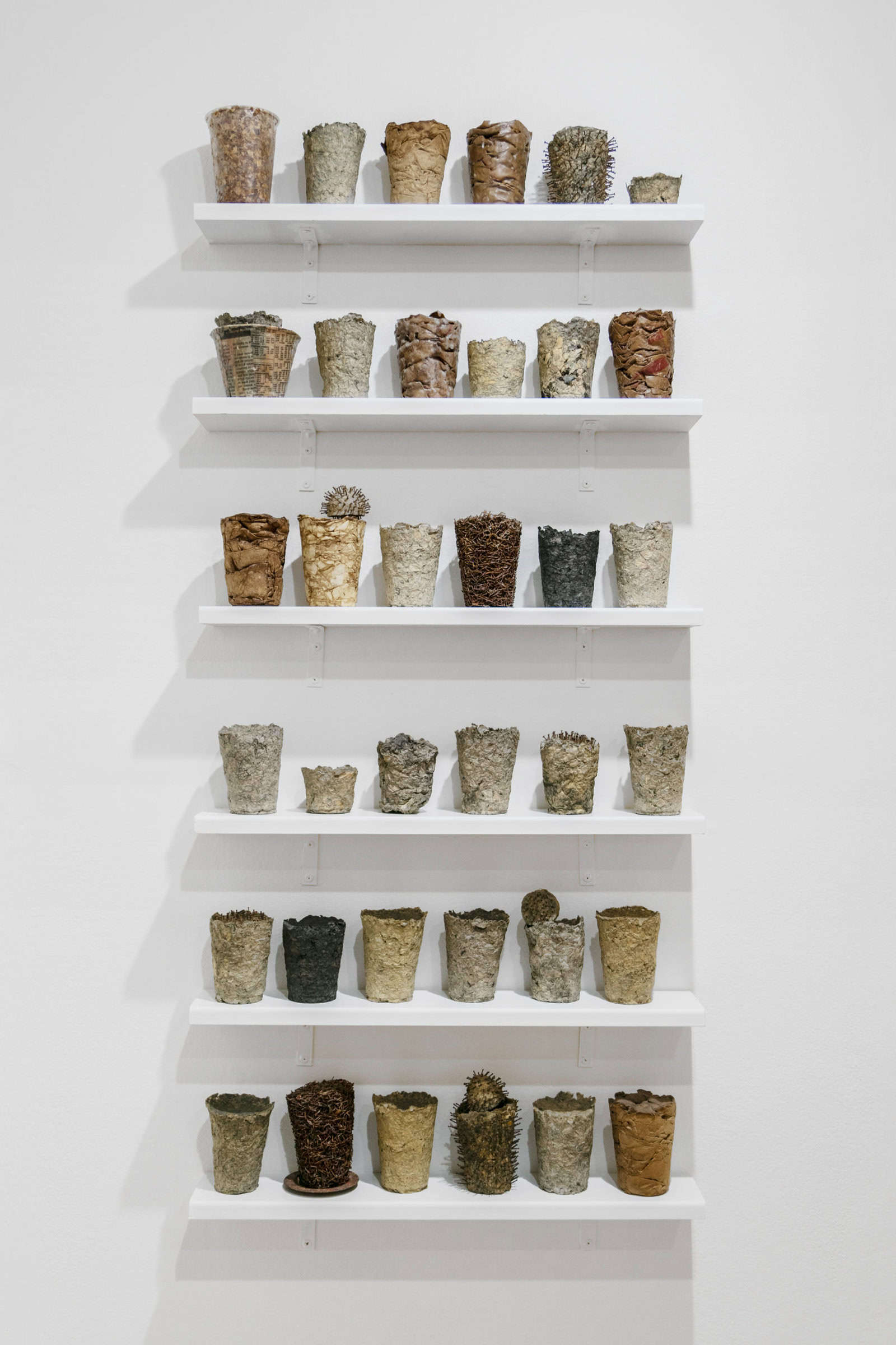 Echiko Ohira, Cups, 1994-1995. Los Angeles Times newspapers, paper, nails, staples, pins, and glue, 2.75 x 2.75 x 3.5 inches each. Courtesy of the artist.