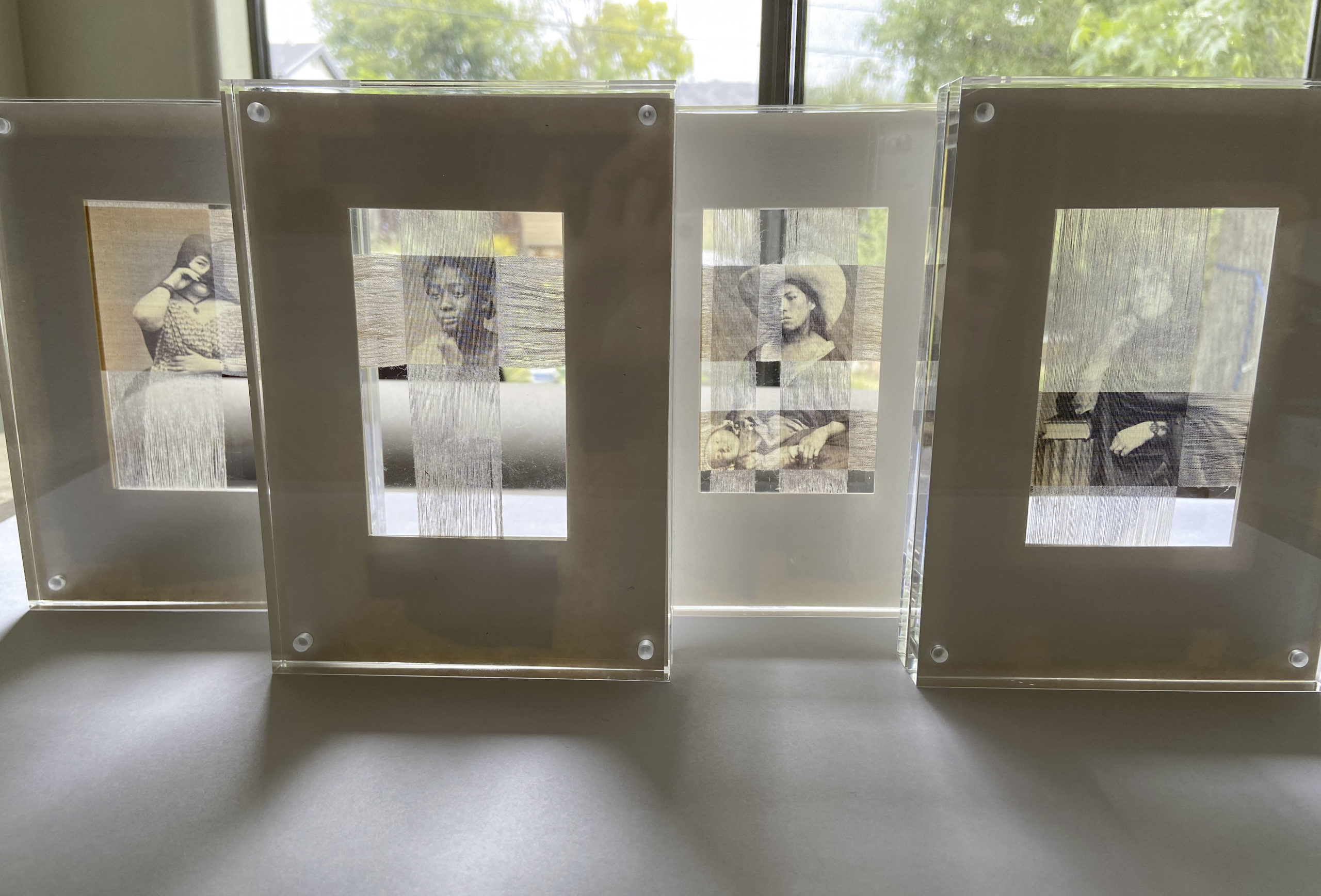 Portraits of Unidentified Women, series of four, glass-encased textiles. From L to R: Witty, Thoughtful, Sensitive, Well-Read. 
