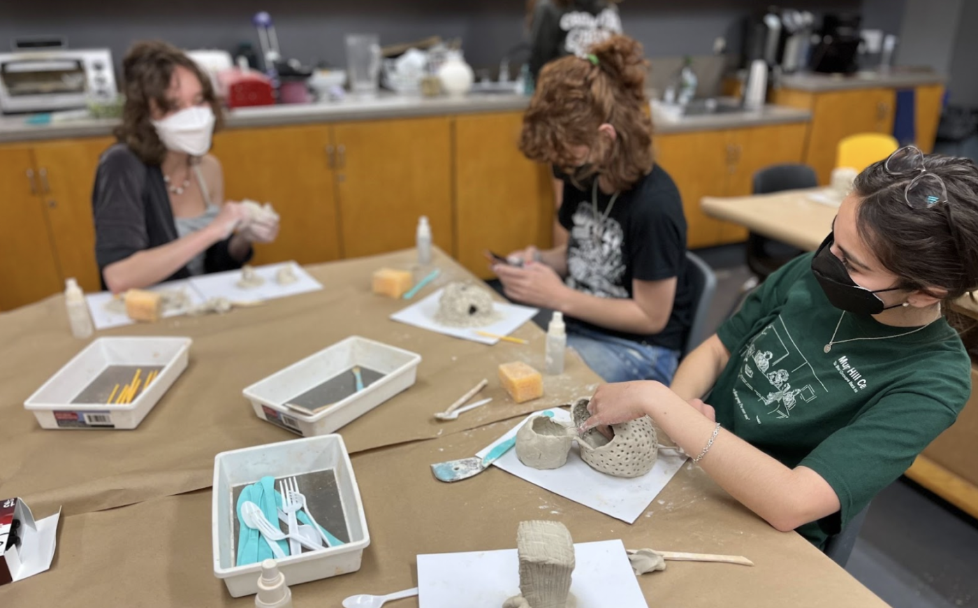 Students creating air-dry clay artworks in the studio.
