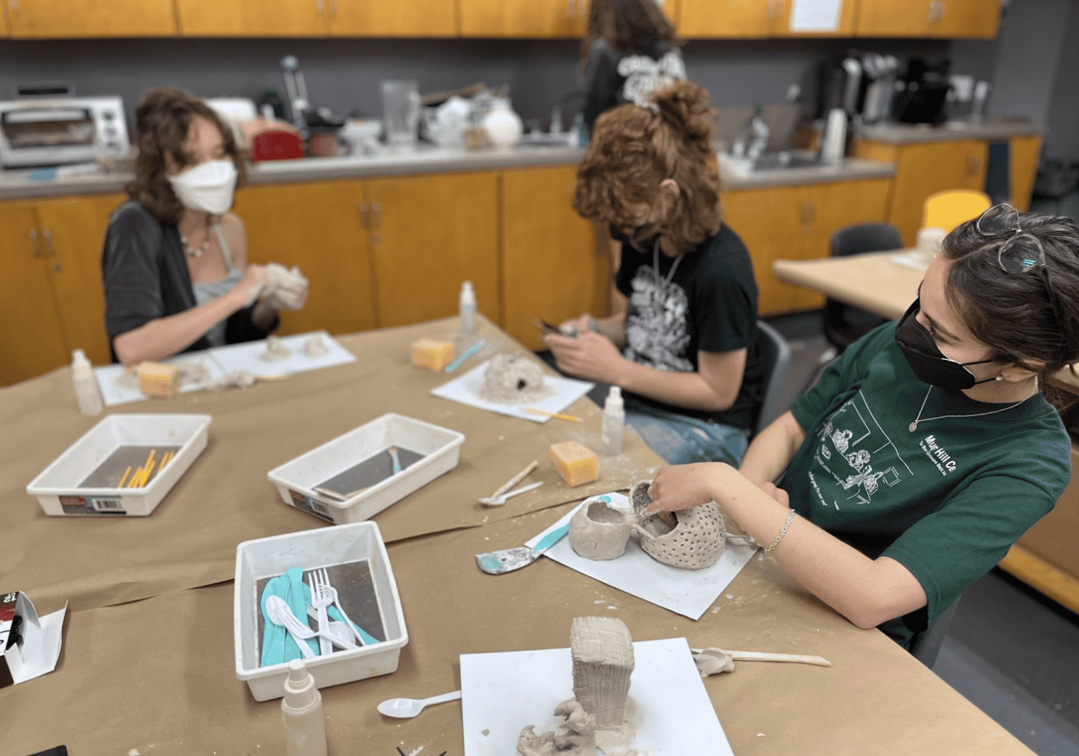 Students creating air-dry clay artworks in the studio.